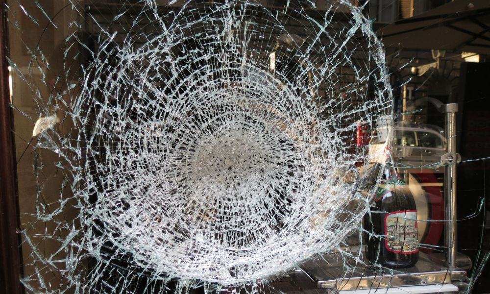 Shattered-window-with-security-film-for-impact-resistance-and-debris-protection