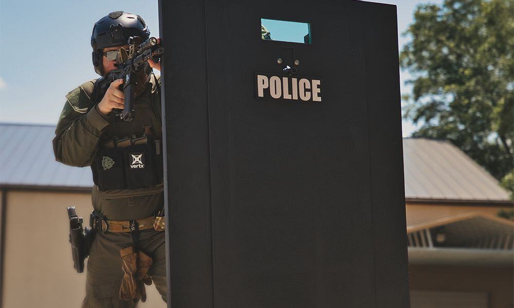 officer using a mobile ballistic shield during a tactical operation